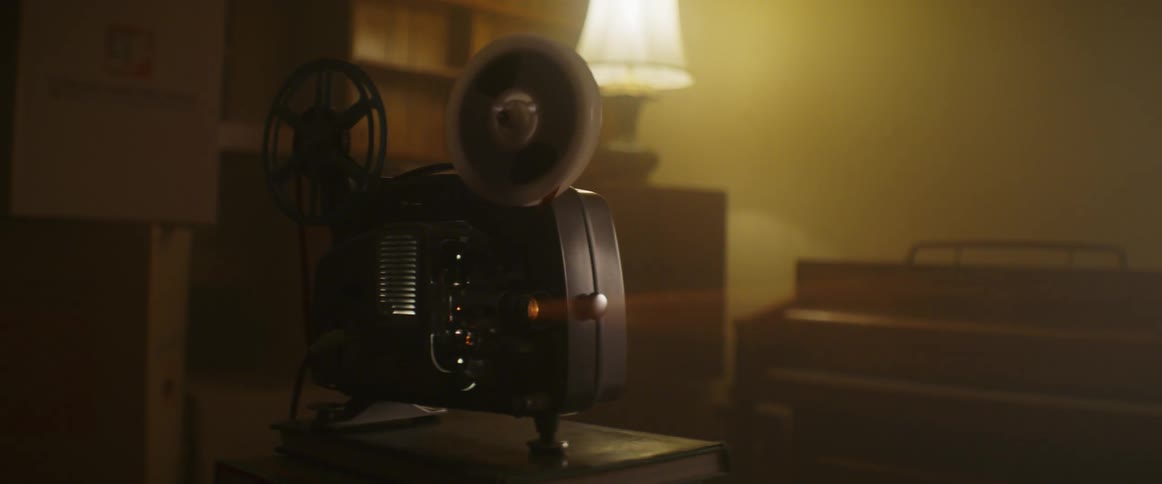 A vintage film projector playing in a home