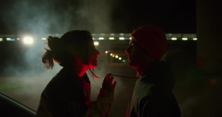 A couple standing outside near each other flirting and chatting