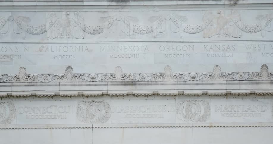 Carved relief of states and their dates on marble