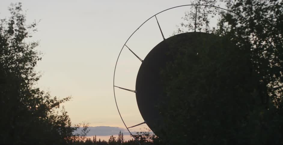 Close up of a large satellite dish at sunset