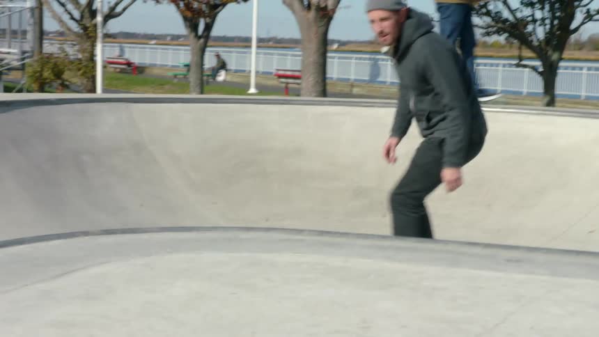 Two men with skateboards at a skateboarding park