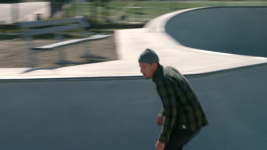 A man is skateboarding in a park