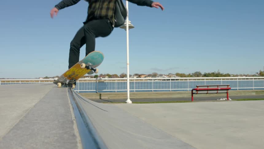 A man is skating in a park on a sunny day