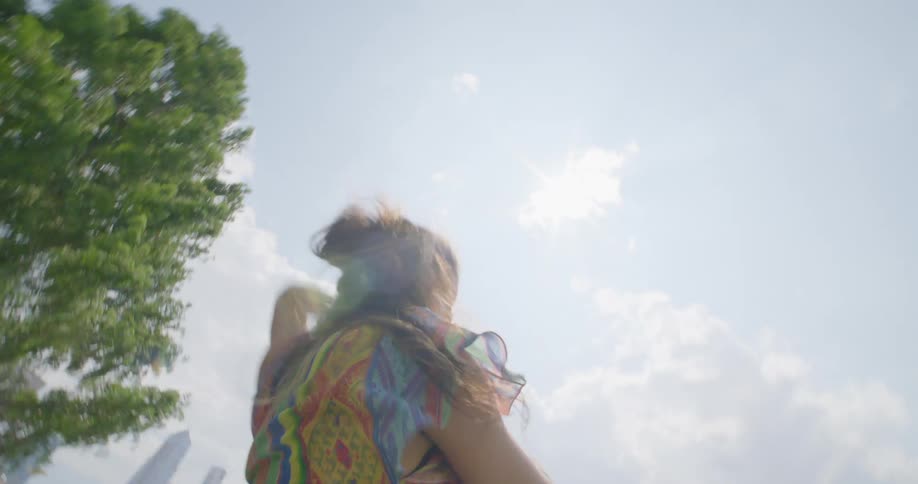 A woman is dancing outdoors in a city