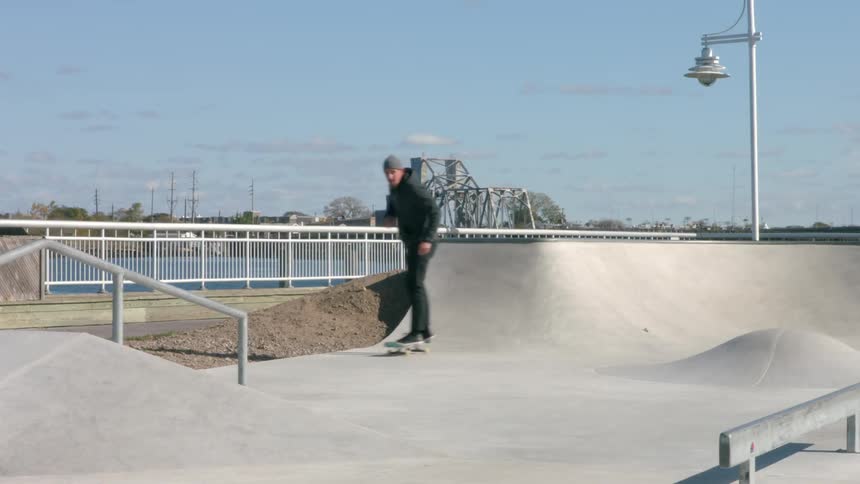 A man rides a skateboard in a park