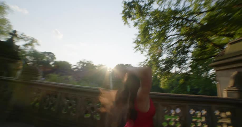 A young woman dancing in a park outside