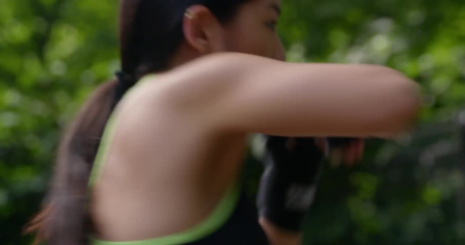 Woman practices martial arts outdoors