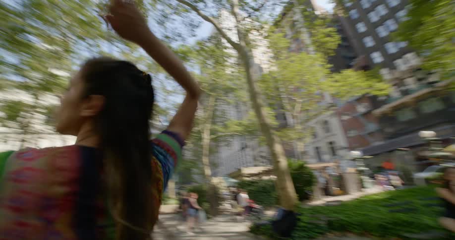 A female dancing outside in a downtown area