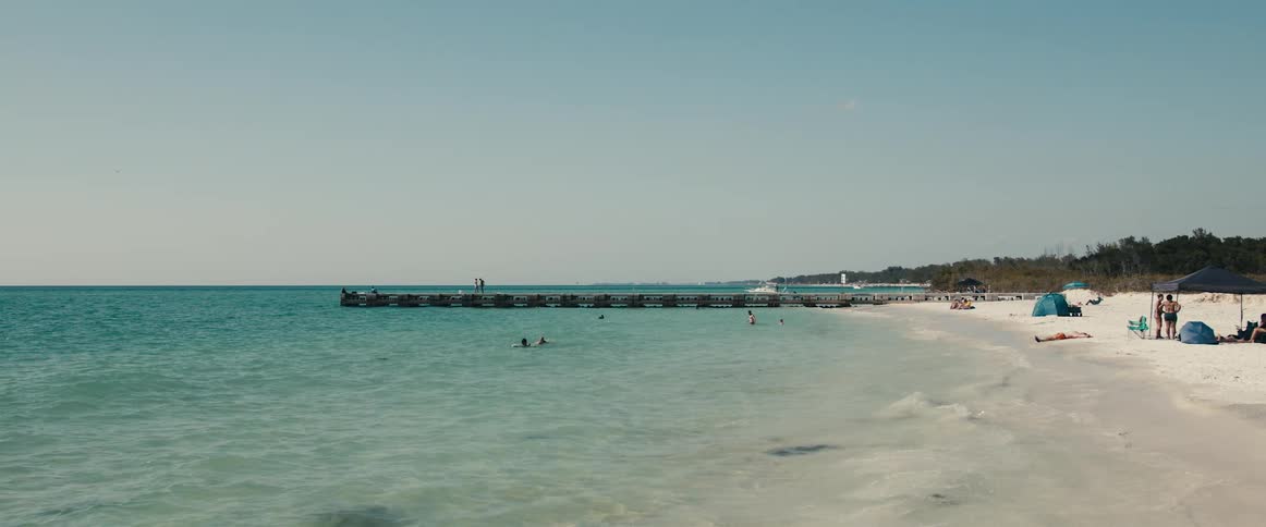 People relaxing on a beach and playing in the water