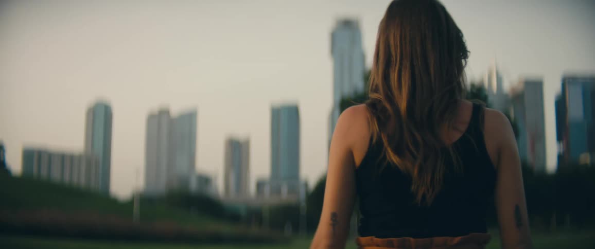 A woman is walking outdoors in a city