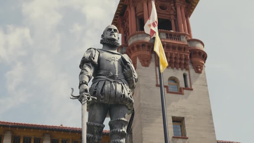 A statue in front of a large building