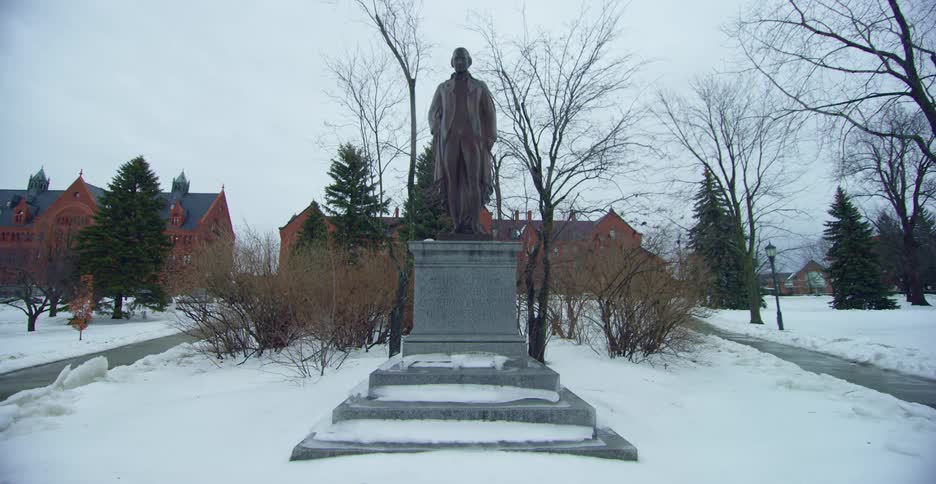 A statue in front of buildings