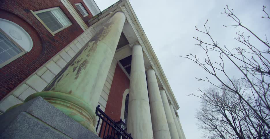 Exterior of red brick building with tall columns
