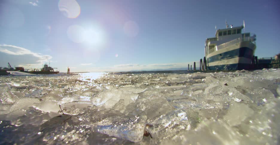 A ship docked on an icy shore in the daytime