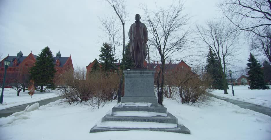 Statue on a park covered in snow in a small town at winter