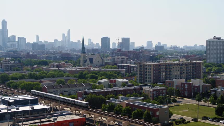 An aerial view of Chicago neighborhood with a train driving through it