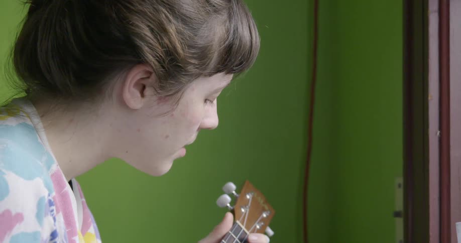 A woman plays guitar