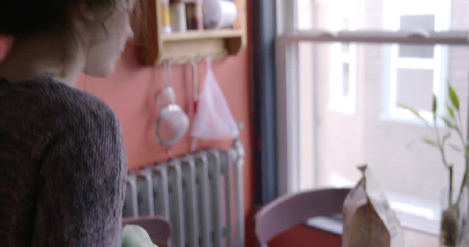 A woman is talking as she walks by a table with food on it