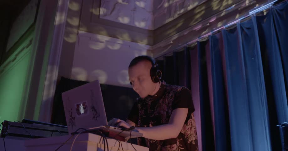 A dj dances to a song at a nightclub