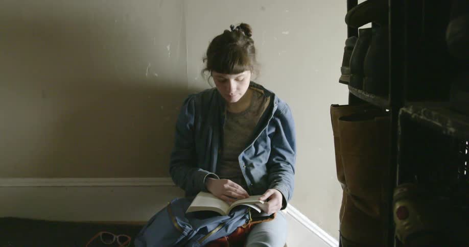 A woman with brown hair reads a book