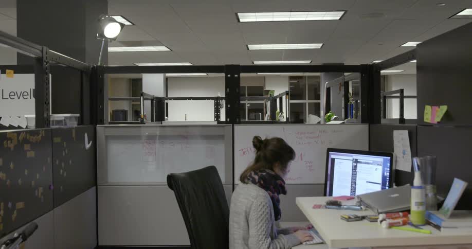 A woman is sitting at a desk typing