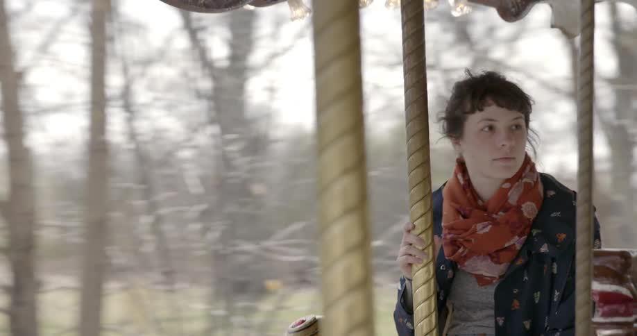 A woman riding a carousel