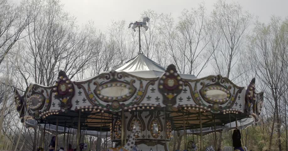 An ornate carousel with moving animals and riders