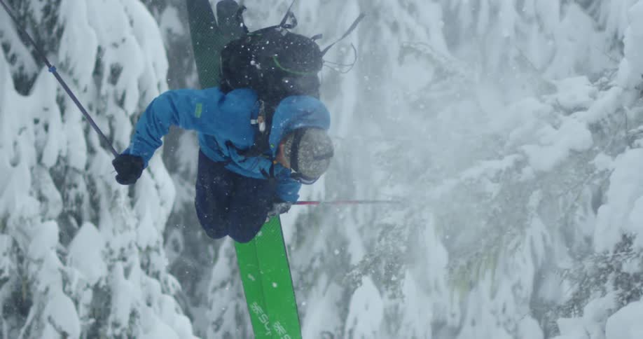 A skier spins through our view, in the forest