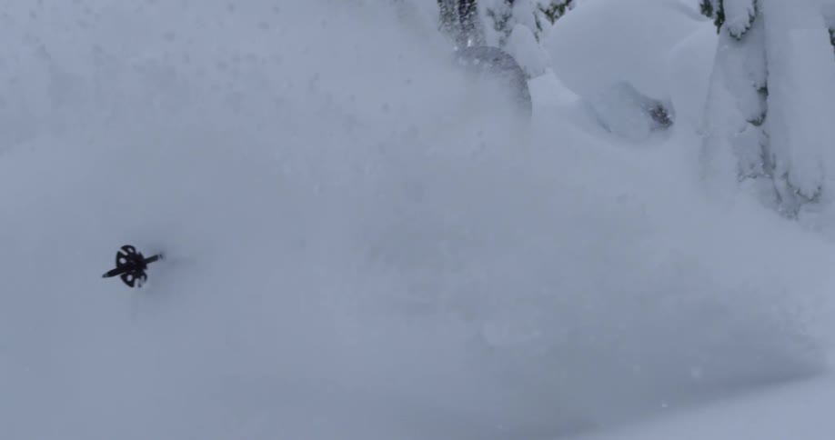 A skier sprays a wall of deep snow