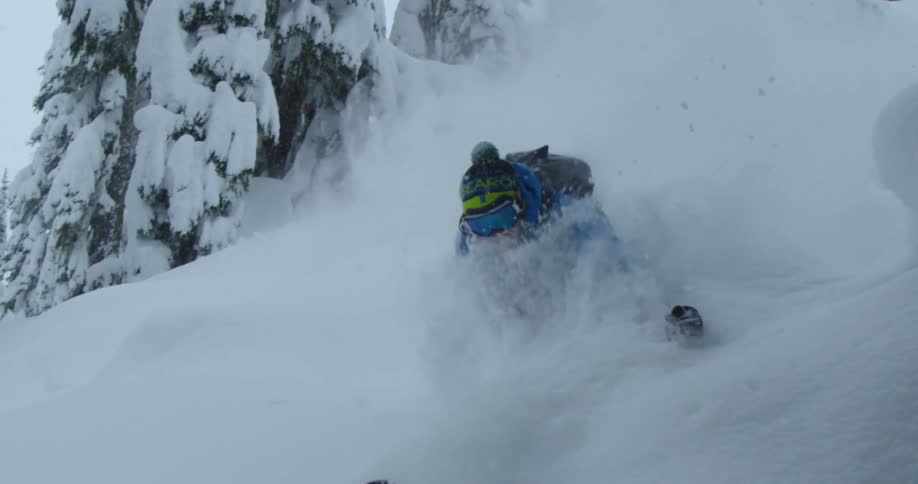 Snow streams around a skier in deep powder