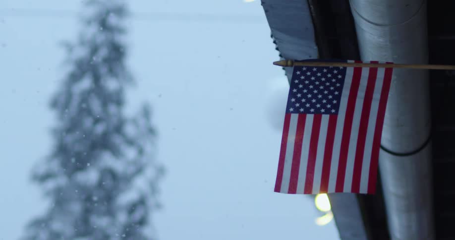 An American flag in a snowstorm
