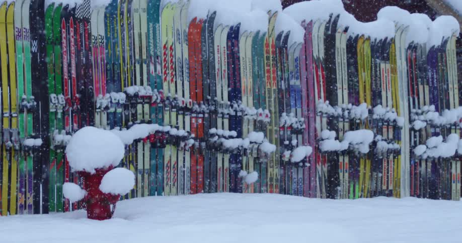 A fence made of skis in heavy snow