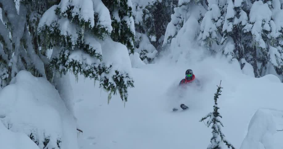 A skier airs through deep powder snow