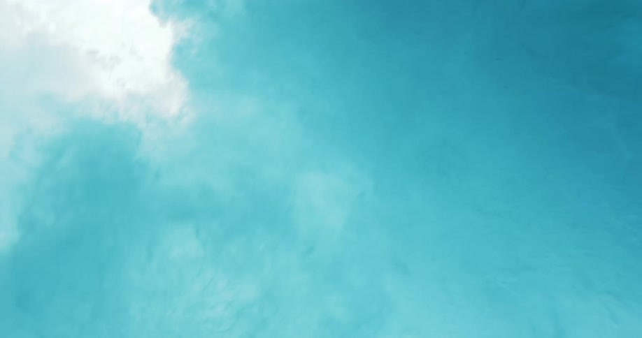 Blue and white clouds swirl roil and dissipate underwater