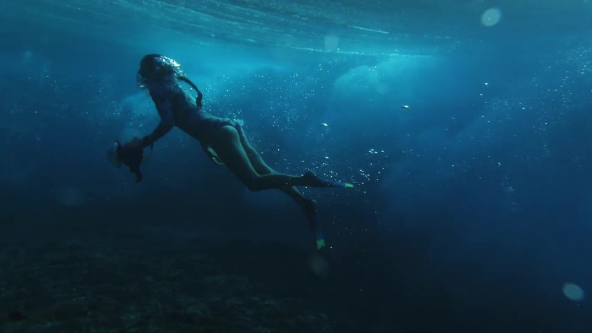 Female diver underwater taking pictures