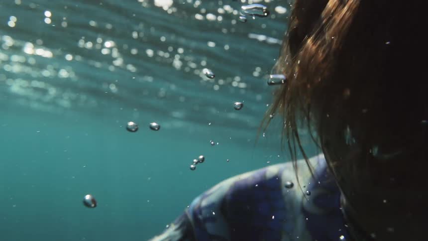 A woman swimming under water