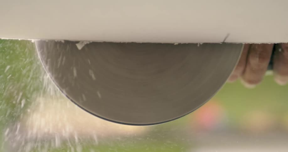 A person using a power tool to sand