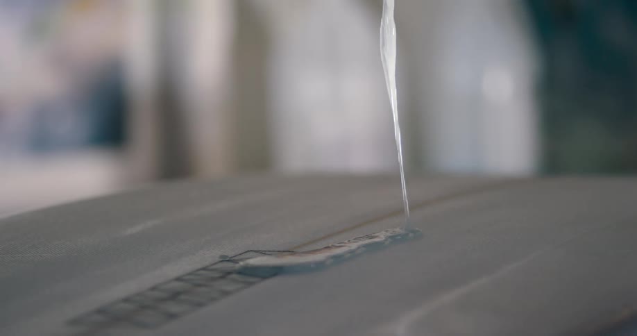 Blue thick gel spilling over a white surface