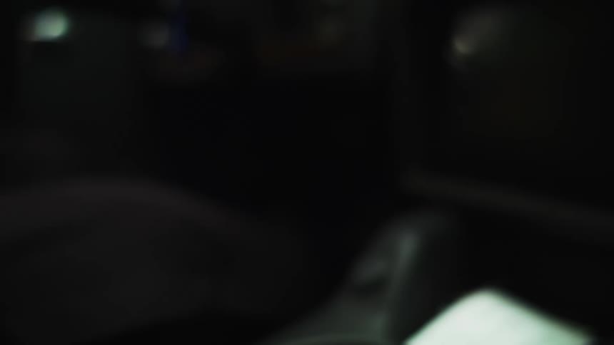 A person moving a devil gear shift in a vehicle