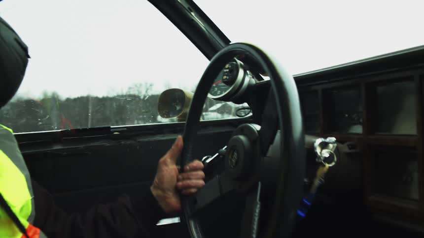A man is driving a car in winter