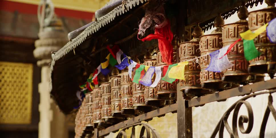 A colorful banner hanging in front of an asian building