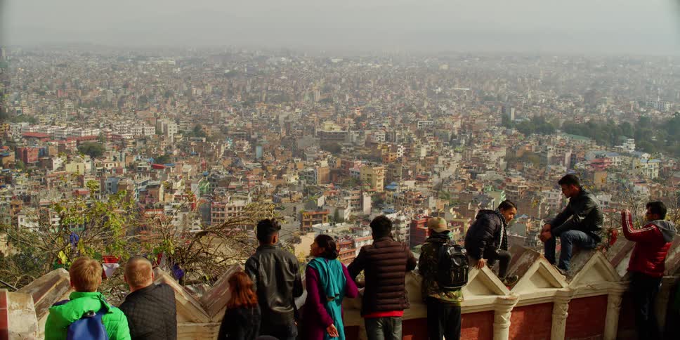 A group of kids looking down at a city skyline