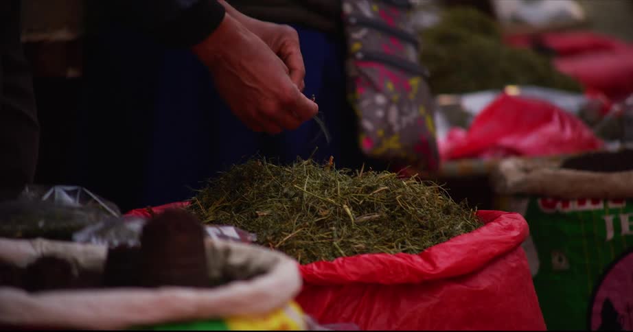 People selling spices and herbs on an open market in asia