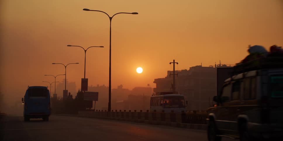 Vehicles driving on a highway on the city at sunset