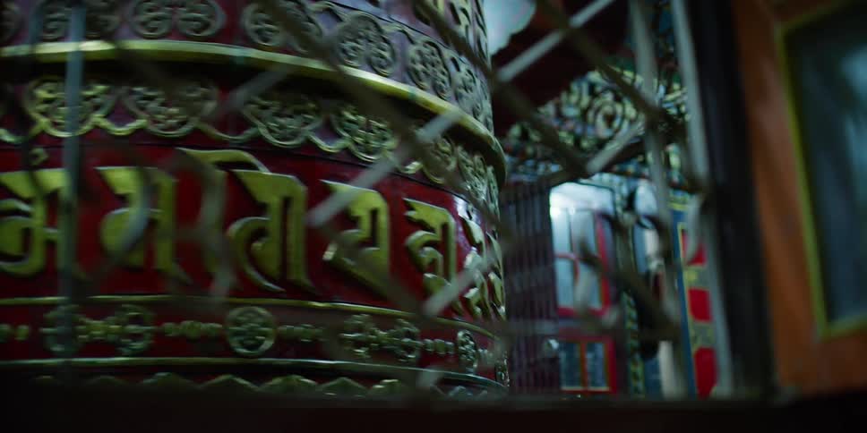 Metallic tibetan prayer wheel spinning