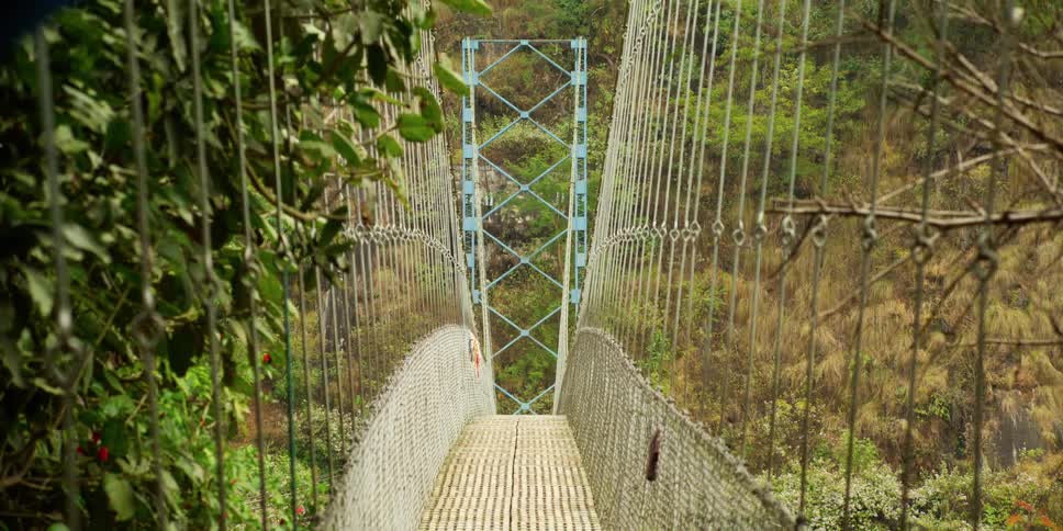 Pedestrian suspension bridge or canopy walkway in the mountains