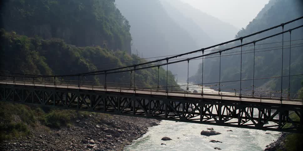 Water is flowing under the bridge in spring