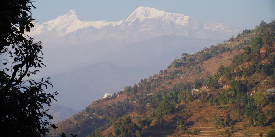 An aerial view of a mountain is displayed during midday