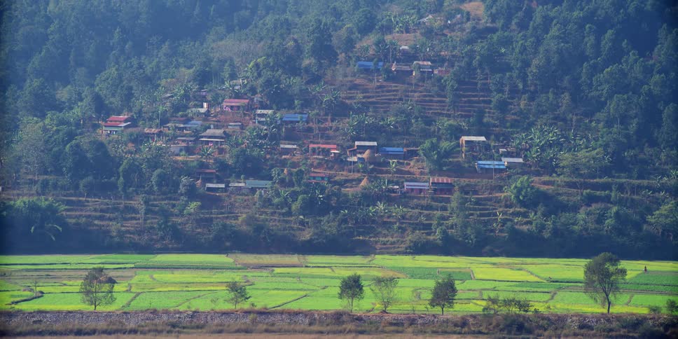 Farmland in front of houses on a hill