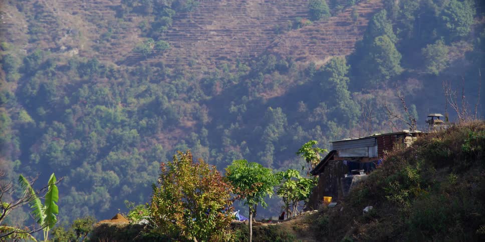 A makeshift building on the slope of a mountain on a sunny day